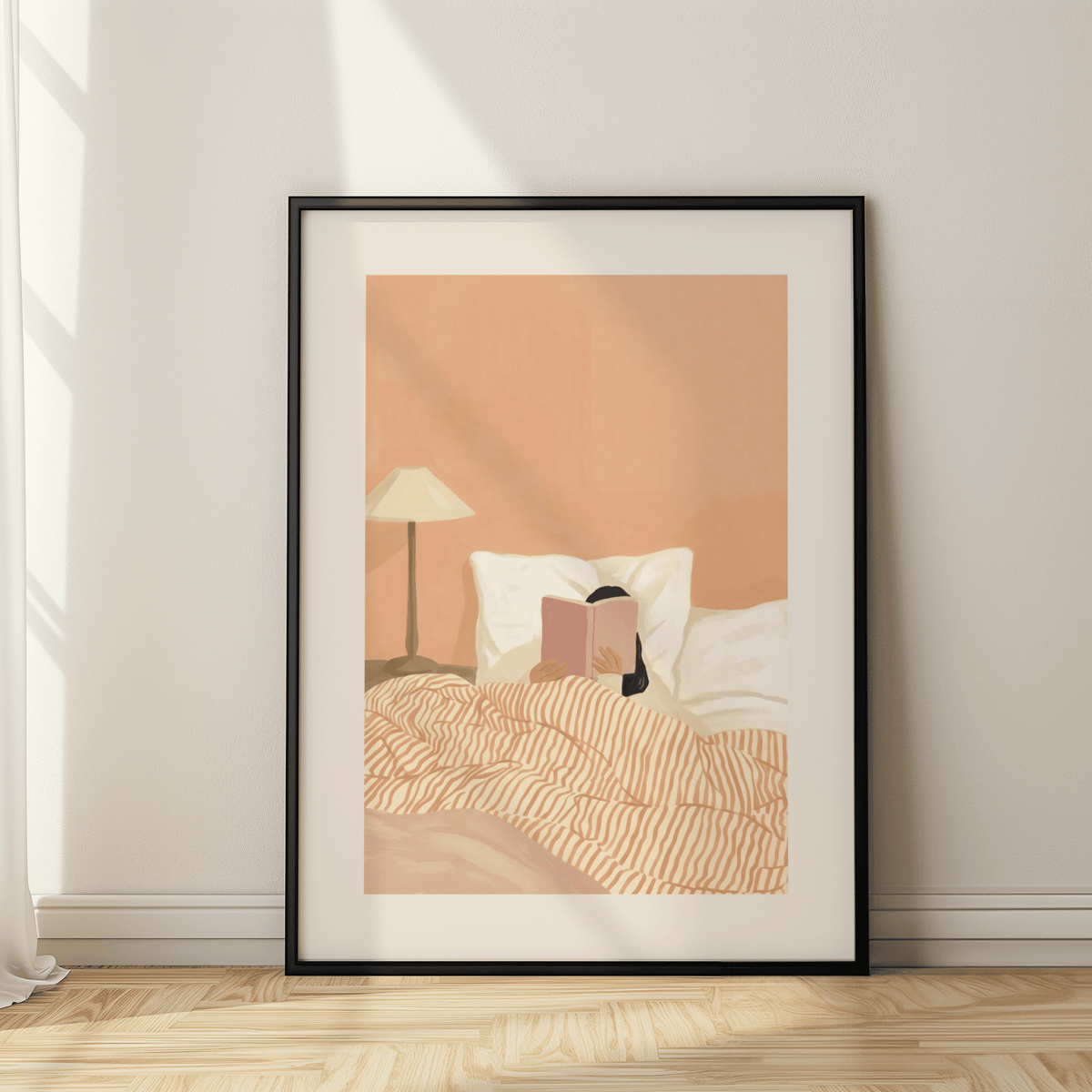 Framed close-up of woman reading book art with warm colours and a lamp on the bedside