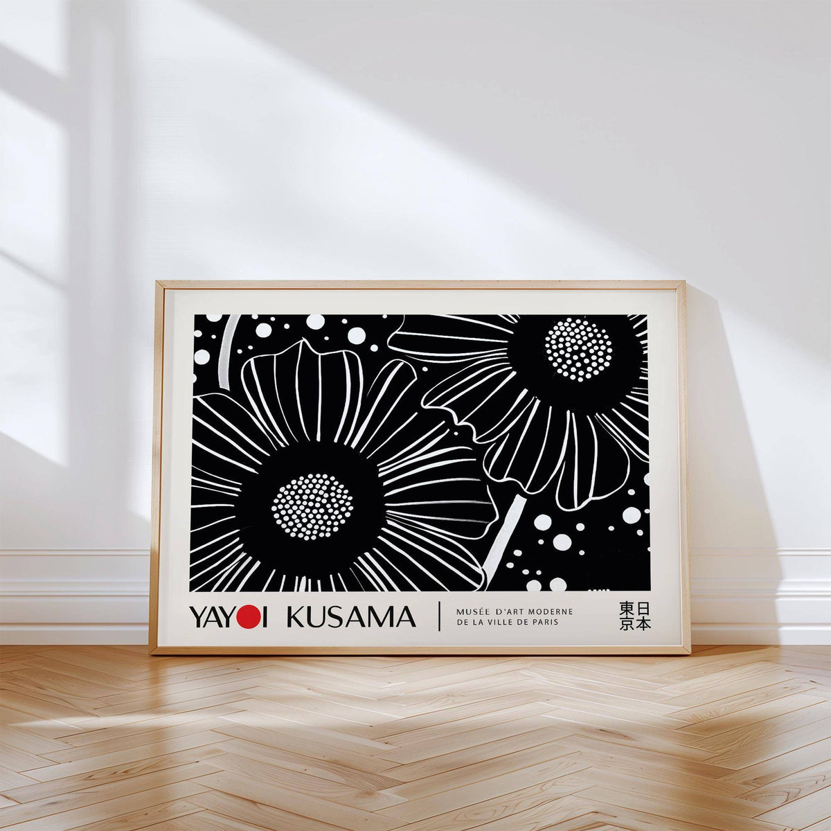 Horizontal wall hanging of black and white minimalist flowers leaning on wooden floor with light and shadow