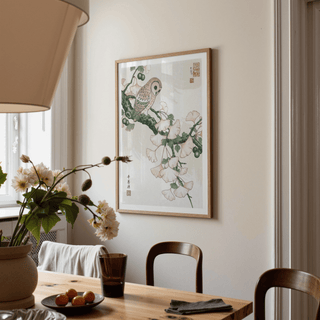 Owl art print in Japanese woodblock style with soft pink and green hues in a dining room