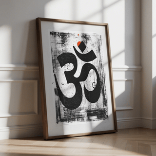 Framed Abstract Om Art Print leaning on floor showing black and white design with orange accent