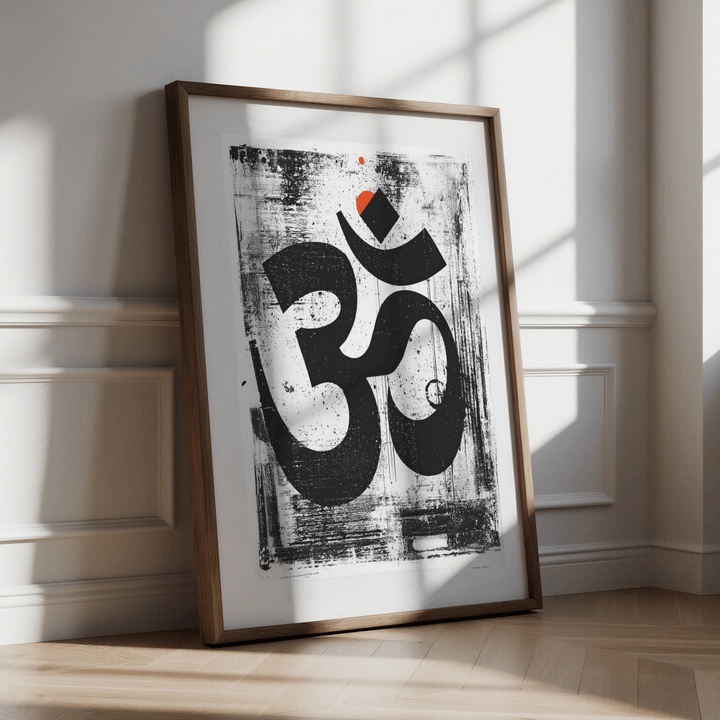 Framed Abstract Om Art Print leaning on floor showing black and white design with orange accent