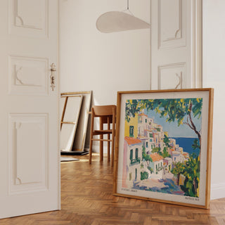Print leaning on a floor of Positano Art showing an Italian coastal village in vibrant watercolours with greenery