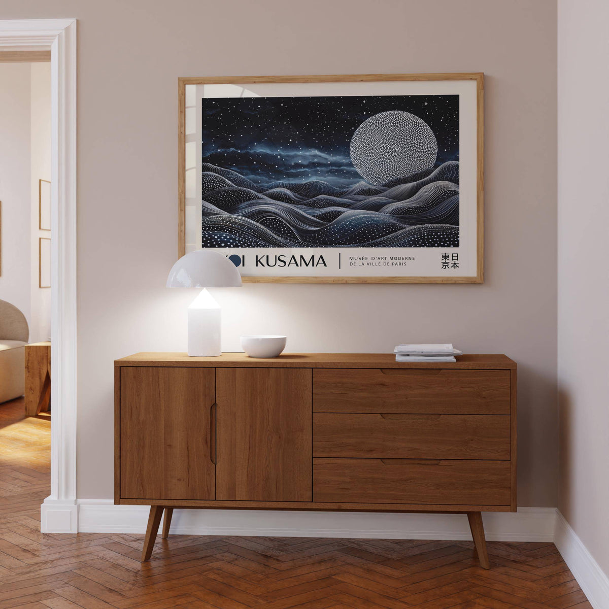 Space Art Wall framed print of a large dotted moon over waves above a wooden sideboard with lamp