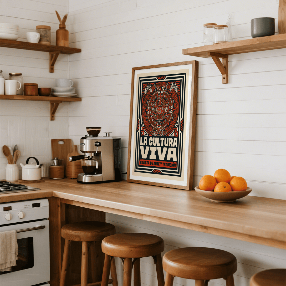 Print leaning on a kitchen counter featuring Aztec Culture Art Print with red and beige folk-art style next to a bowl of oranges