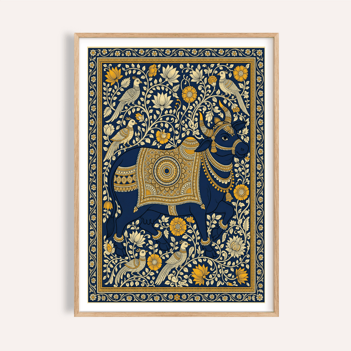 Framed Indian art print of a decorated blue cow with yellow and cream floral details