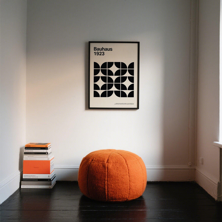 Pictures for Home Office minimalist black and white geometric print in a black frame above an orange pouffe and stack of books