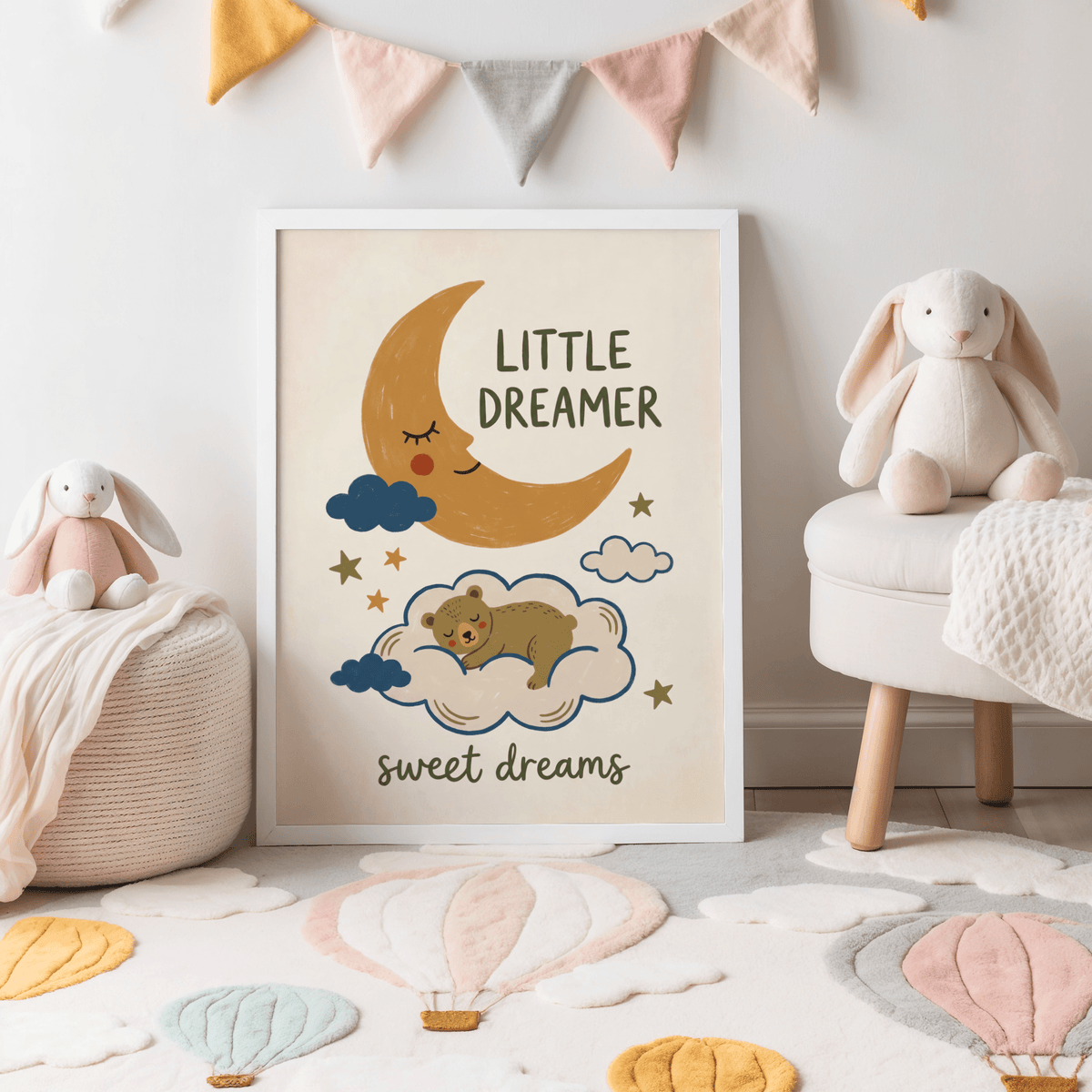 Little Dreamer wall art with sleeping bear on a cloud in a child's room with soft toys and pastel bunting