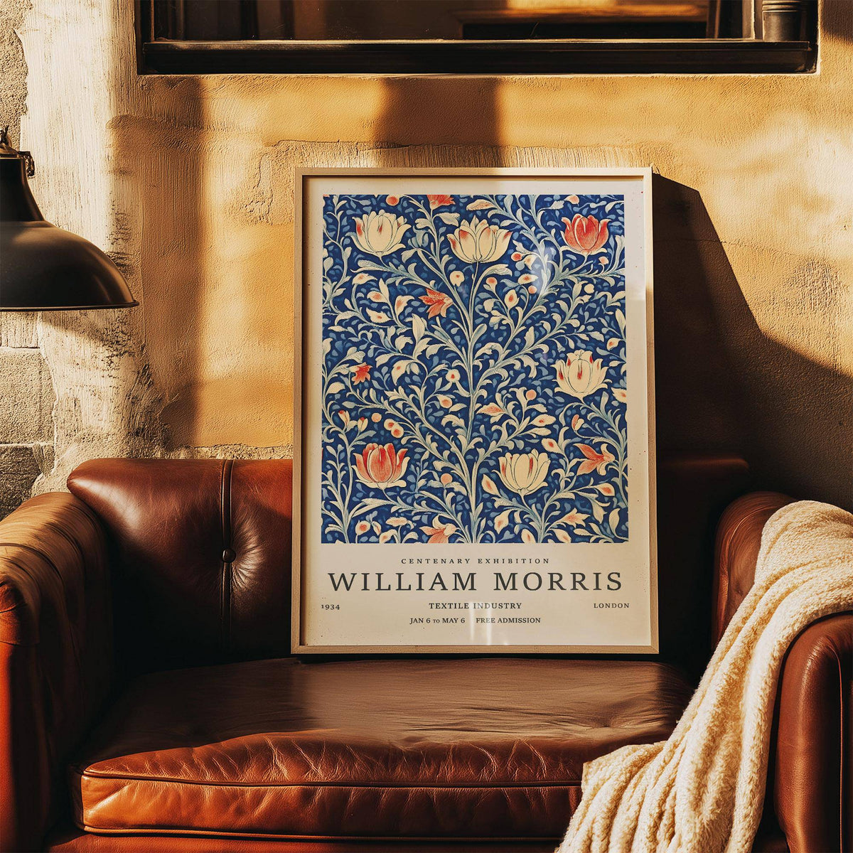 Vintage Flower Wall Art leaning on a brown leather sofa with warm light on a textured wall
