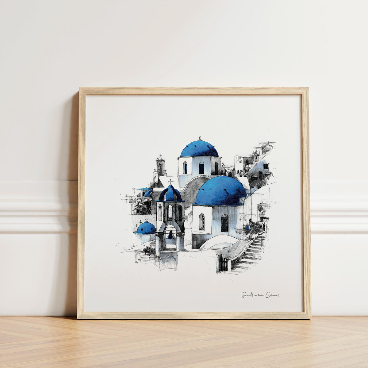 Santorini wall art of blue domed churches leaning on a floor against a white wall
