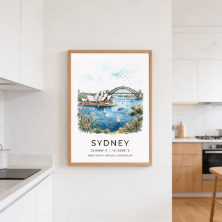 Sydney Watercolor Art Print on a kitchen wall with natural wooden frame and white cupboards