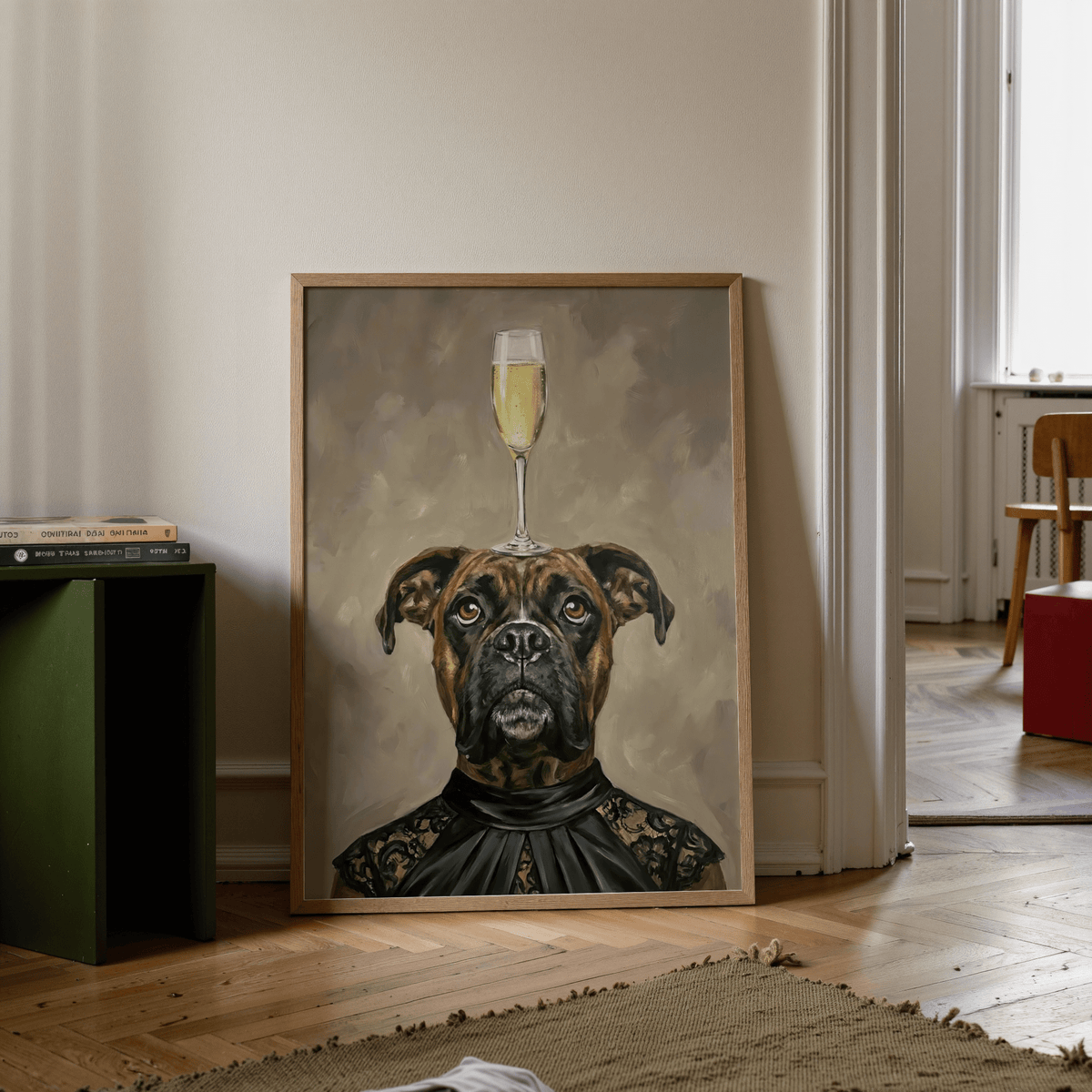 Boxer Dog Print leaning on floor beside books and green side table in a bright room
