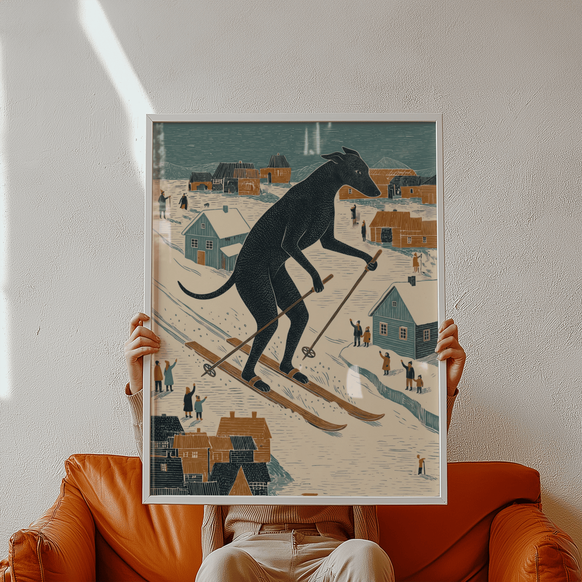 Framed Skiing Dog Art Print of a black dog skiing illustrated in folk-art style held by hands above a brown chair