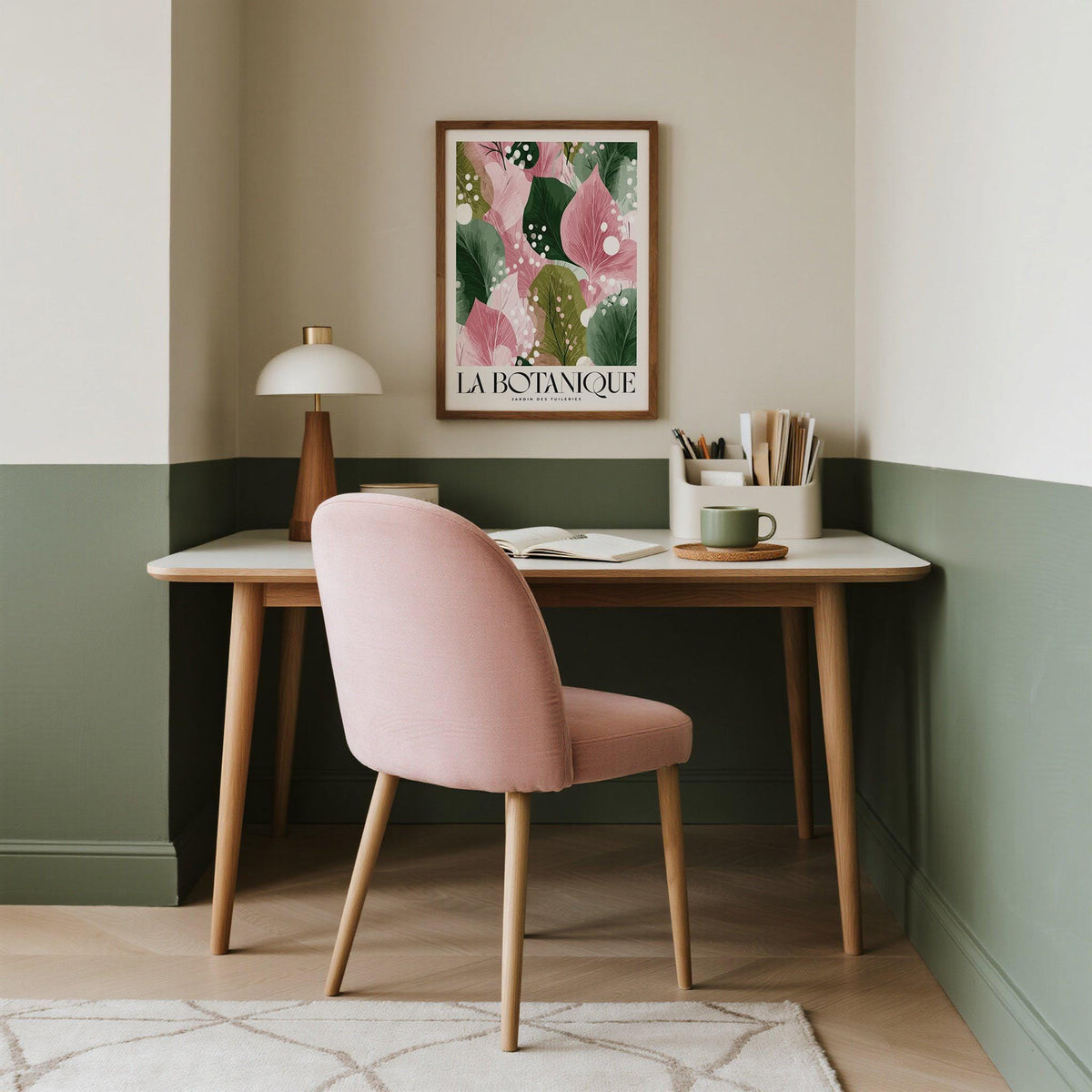 Floral Abstract Print framed print with pink and green abstract leaves above a desk with pink chair in a study