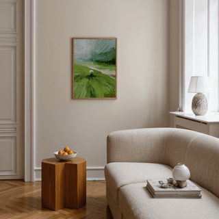 Abstract green wall art of a golf ball on a tee in an airy living room with a beige sofa