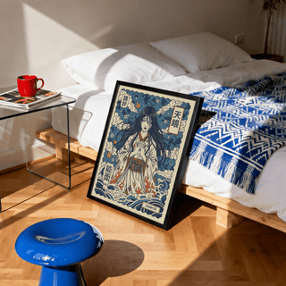 Japanese Ghost Print leaning on a bedroom floor with a blue patterned throw on the bed and a red mug nearby