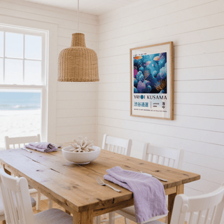 Fish artwork prints of colourful coral reef and fish in a bright dining room with a wooden table