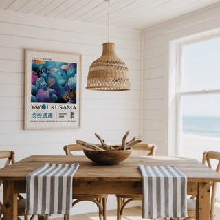 Fish artwork prints of a colourful coral reef with fish in a light dining room with a wooden table