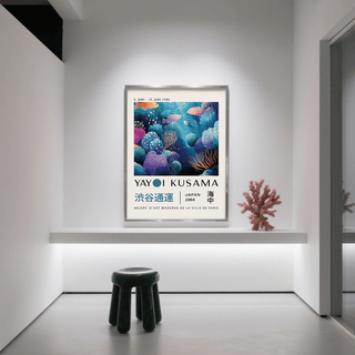 Fish artwork prints with colourful coral reef and fish in blue and purple tones next to a coral sculpture