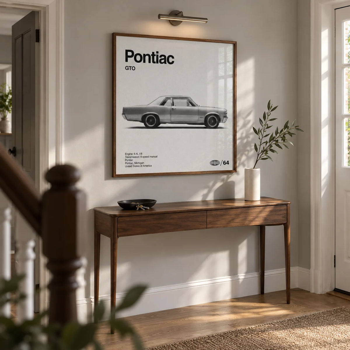 1960s Muscle Car Wall Art, framed on the wall of a broad entrance hallway in a renovated UK semi-detached home with a pale grey wall and oak floor