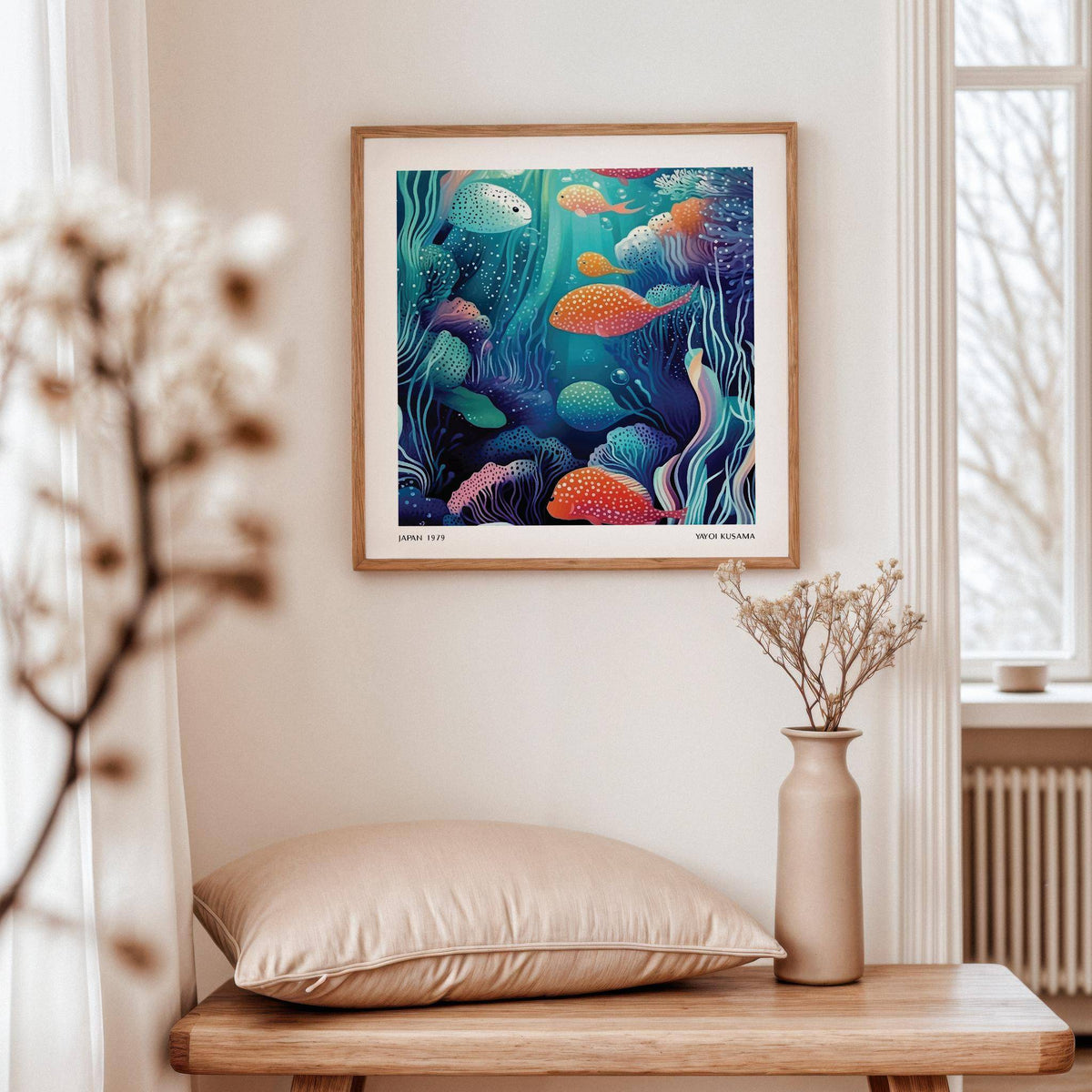 Underwater artwork of colourful spotted fish in an underwater scene above a wooden table with a beige pillow and vase