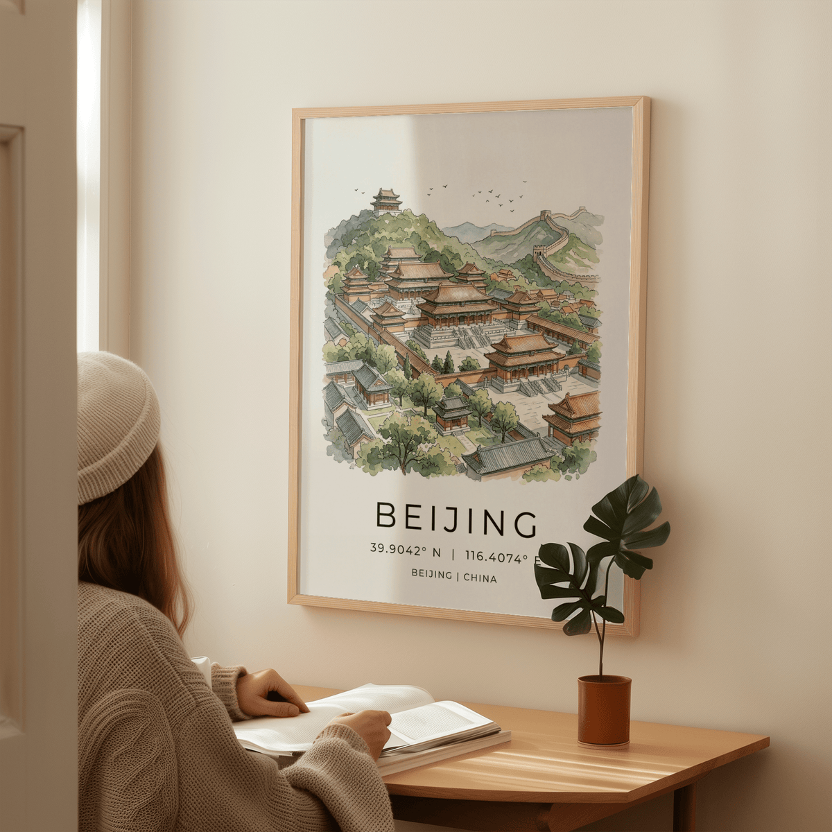 Beijing wall art in watercolour illustration style above a wooden desk with a small potted plant