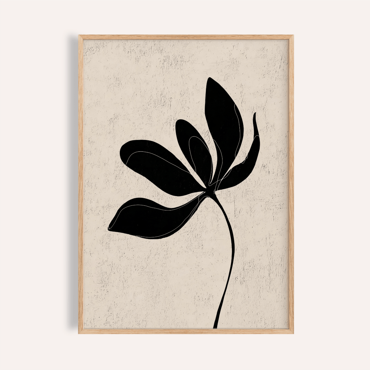 Framed minimalist botanical wall art with black leaf silhouette on textured beige background