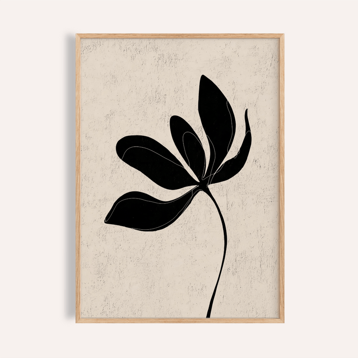 Framed minimalist botanical wall art with black leaf silhouette on textured beige background