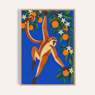 Monkey wall art with a monkey hanging from an orange tree on cobalt blue