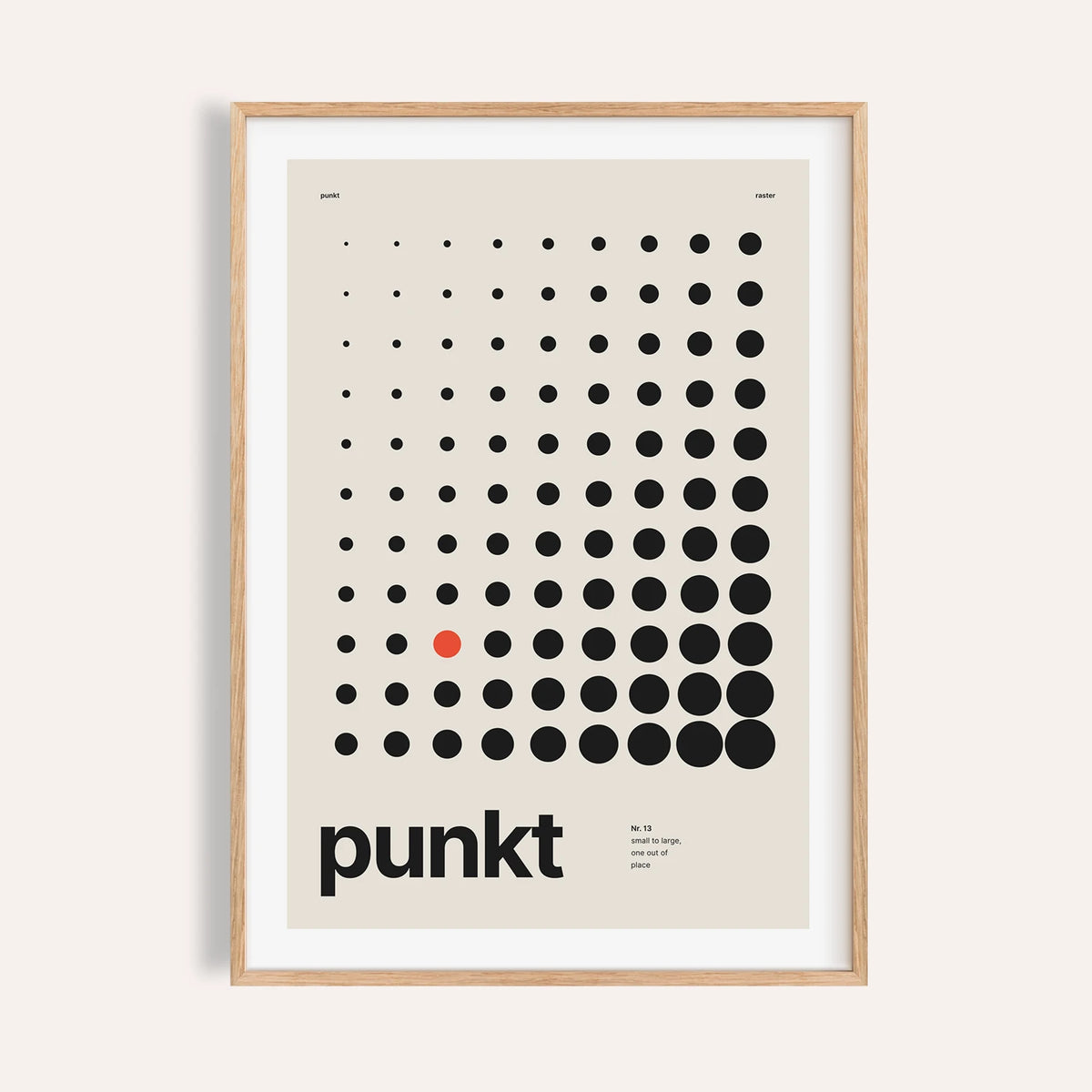 Halftone dot grid print shown on a plain warm wall