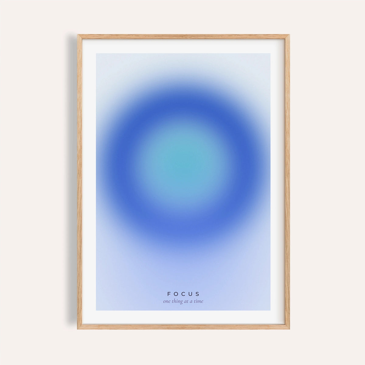 Deep blue and turquoise focus print shown on a plain warm wall