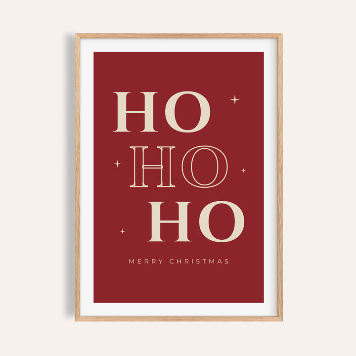 Red ho ho ho typography print shown on a plain warm wall