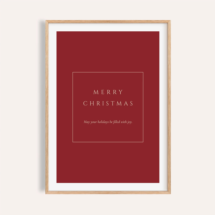 Red Merry Christmas typography print shown on a plain warm wall
