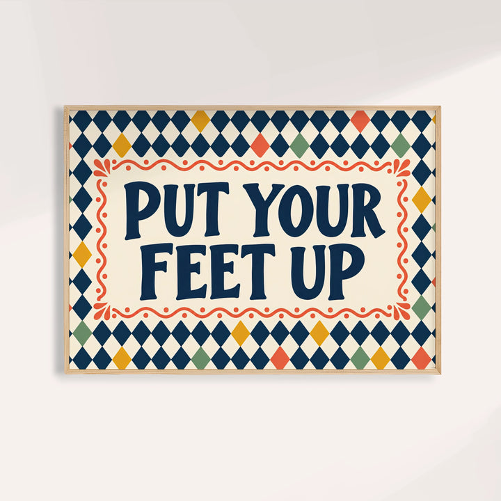 Relaxing wall art reading PUT YOUR FEET UP in navy on a harlequin pattern