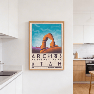 Utah wall art illustration of Delicate Arch in orange and purple framed on a white kitchen wall