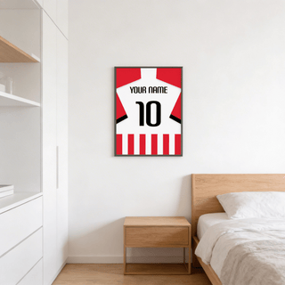 Football Shirt Poster in Red and White Stripes with Black Number hanging above a wooden bedside table in a bedroom