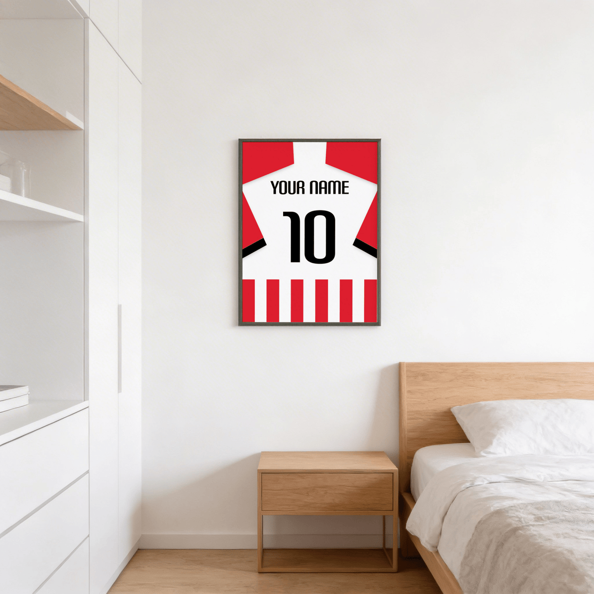 Football Shirt Poster in Red and White Stripes with Black Number hanging above a wooden bedside table in a bedroom