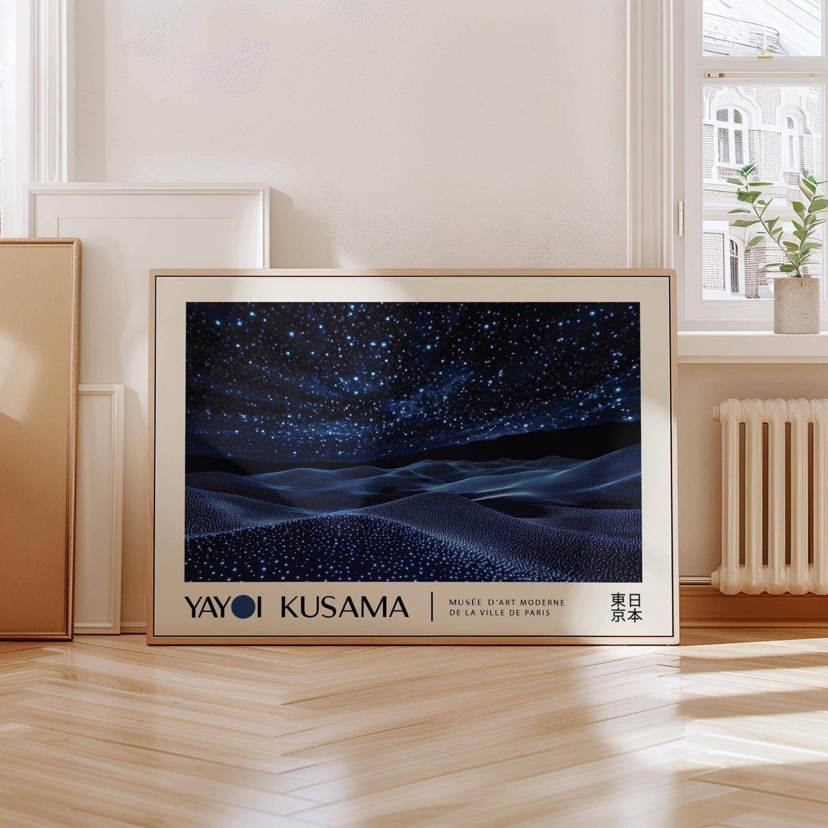 Night Sky Wall Art print leaning on floor with wooden frame and a plant on a window sill