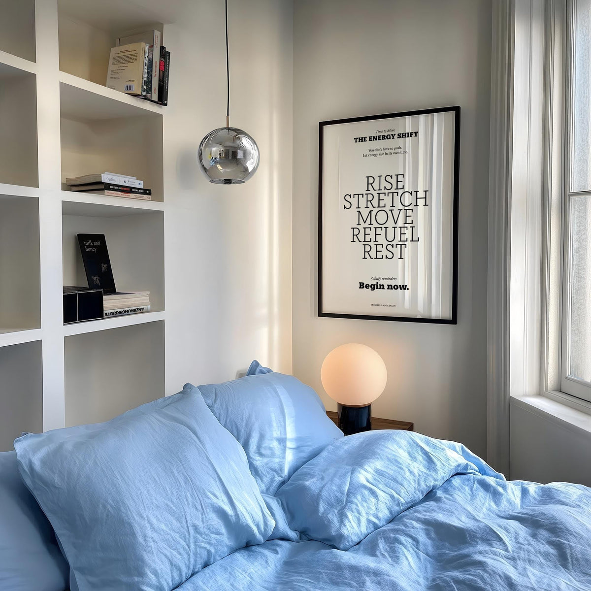 Posters with Inspirational Sayings framed typographic print with black text and white background above a bedside lamp in a bedroom