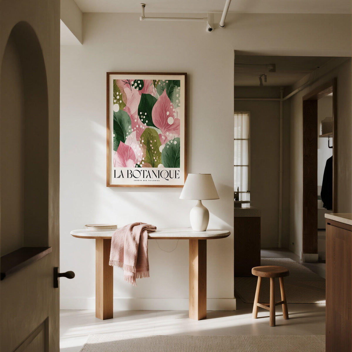 Floral Abstract Print hung on a neutral wall above a table with a lamp and pink cloth