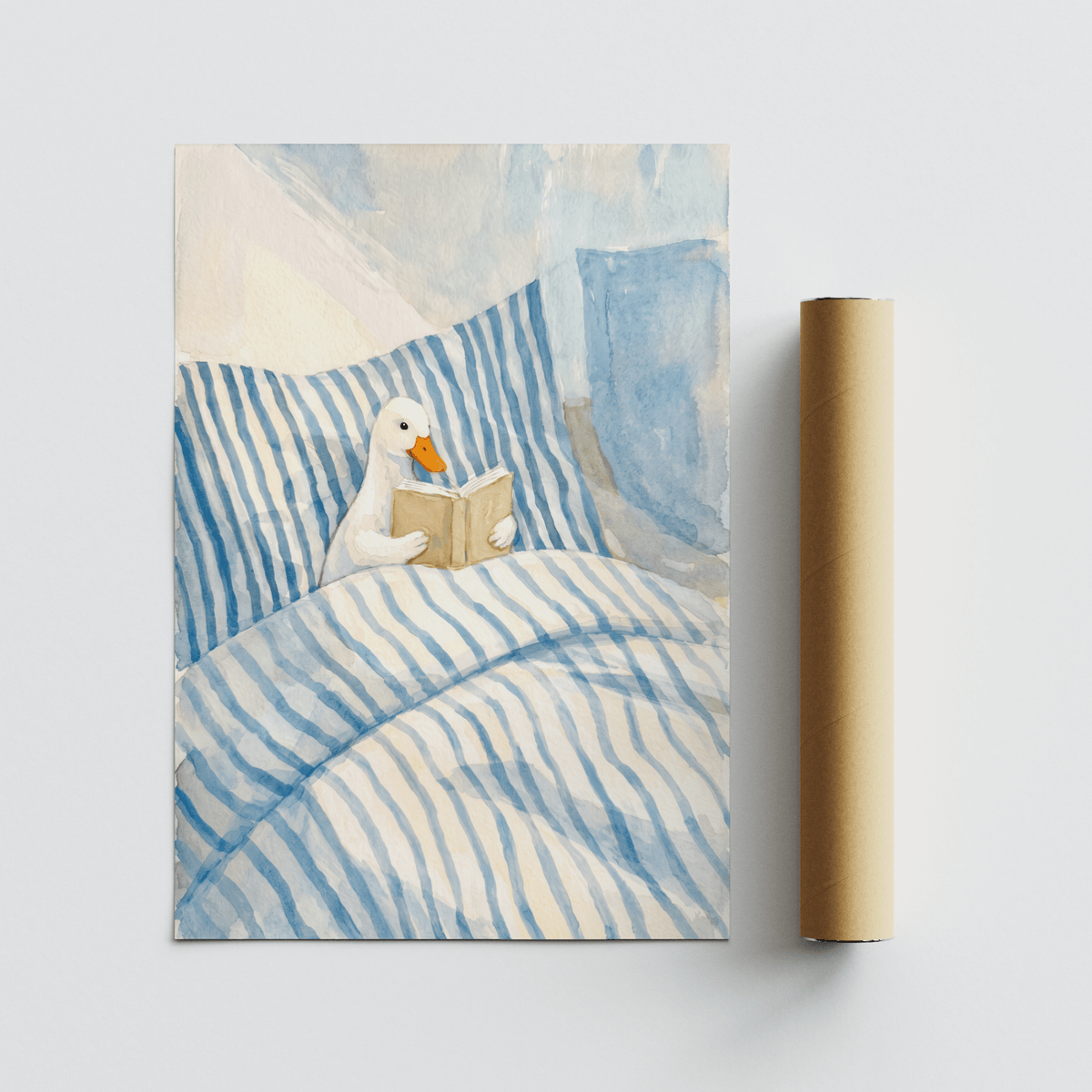 Duck Reading art print with a duck reading in blue and white striped bedding next to a packaging tube