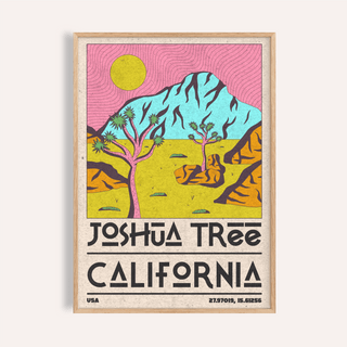 Framed Joshua tree art print with pink sky and yellow sun on a beige wall