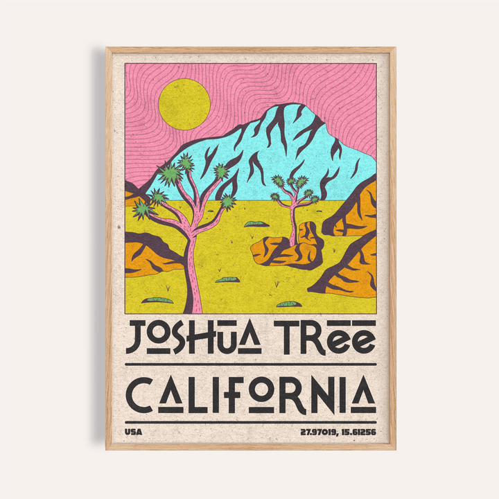 Framed Joshua tree art print with pink sky and yellow sun on a beige wall