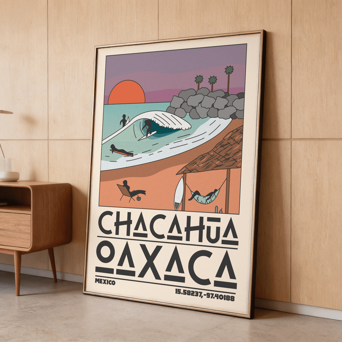 Framed Mexico Beach Art Print leaning on a wooden floor with muted colours and a mid-century style cabinet