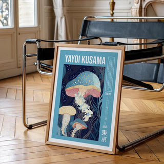 Framed print of jellyfish illustration with blue and pink tones leaning against a black chair