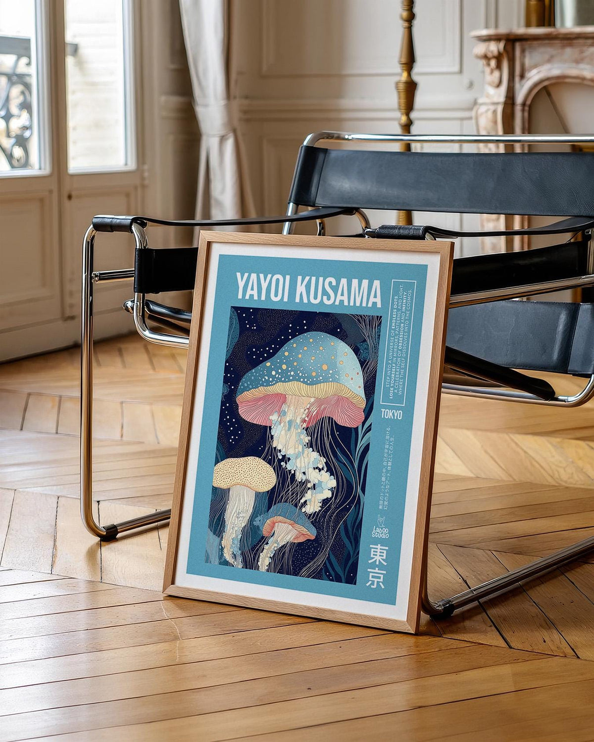 Framed print of jellyfish illustration with blue and pink tones leaning against a black chair