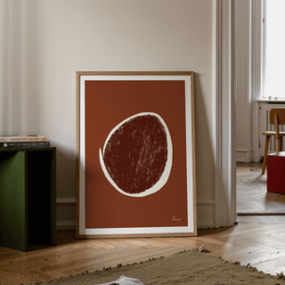 Abstract Earth Tone Art Print leaning on a wooden floor with a green side table beside it