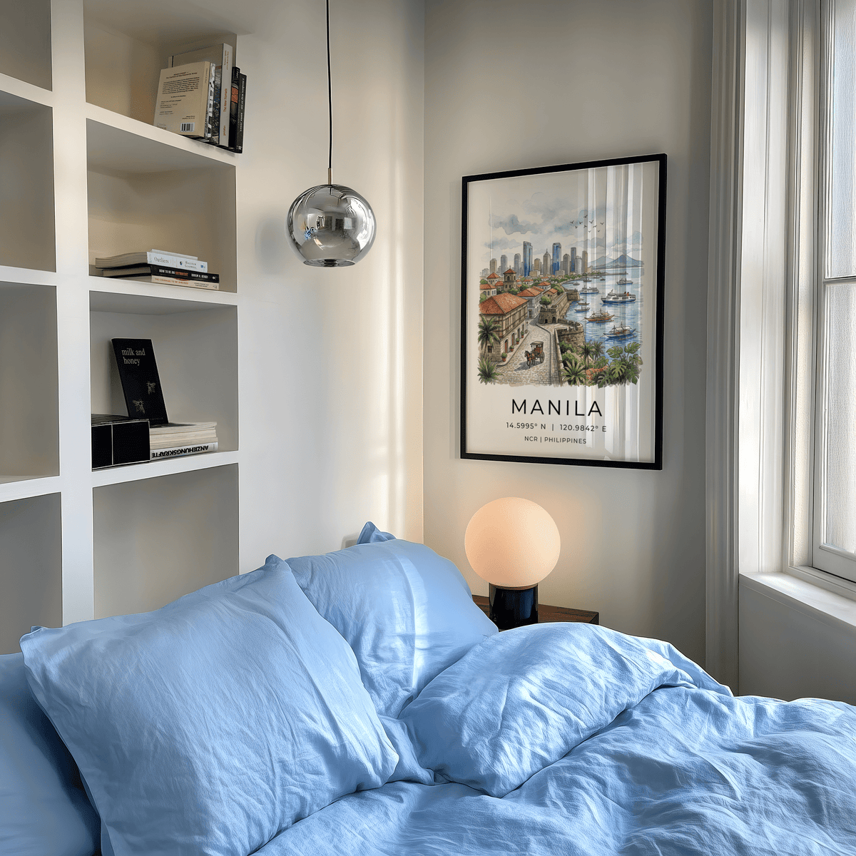 Manila City Art Print framed on bedroom wall above a lamp with blue bedding