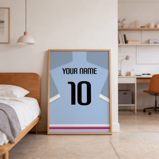 Football Shirt Poster in Light Blue with Black Number leaning on floor next to wooden bed