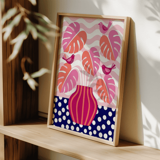 Tropical Plant Wall Art with pink and orange leaves and birds leaning on a wooden shelf