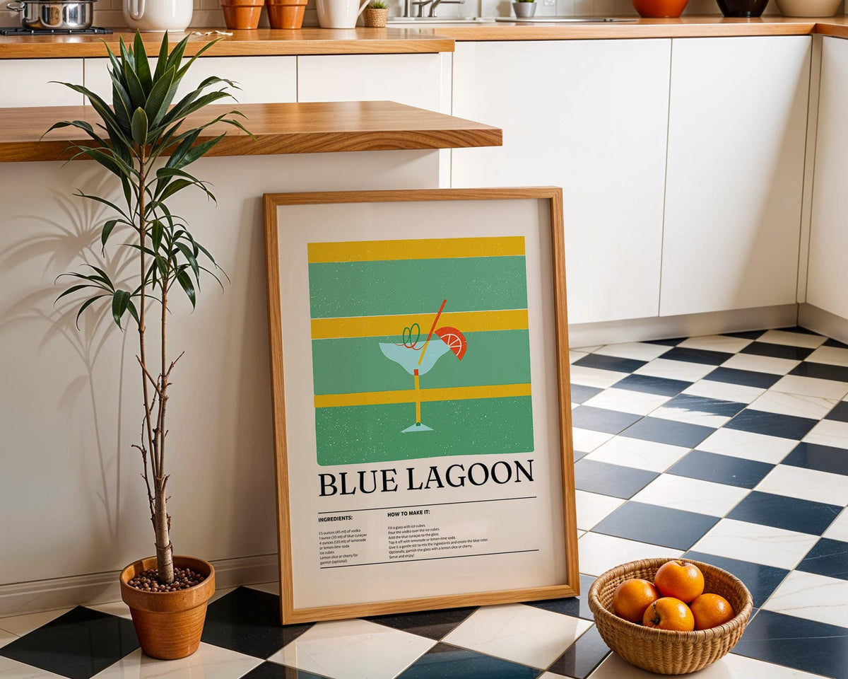 Kitchen wall pictures leaning on a black and white tiled floor beside a potted plant and basket of oranges